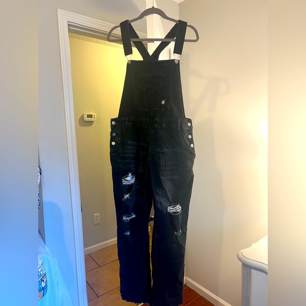 Black overalls with ripped knee